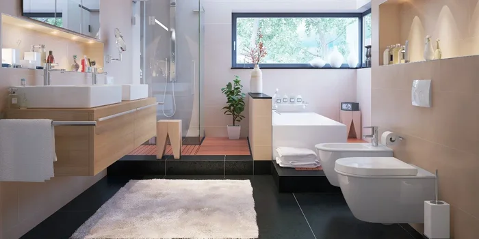 Bad ausgestattet mit WC, Bidet, zwei Waschbecken, einer Duschkabine und Badewanne