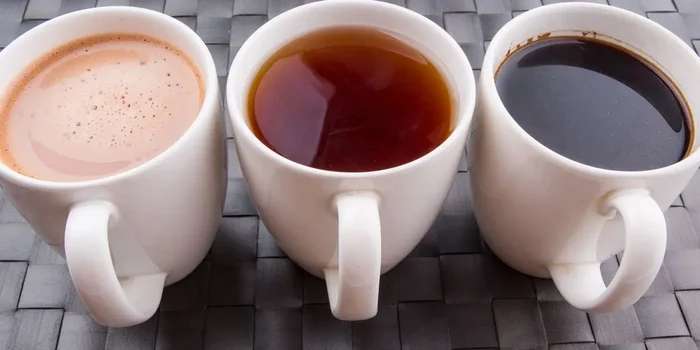 Drei Tassen mit Kaffee, Tee und Kakao